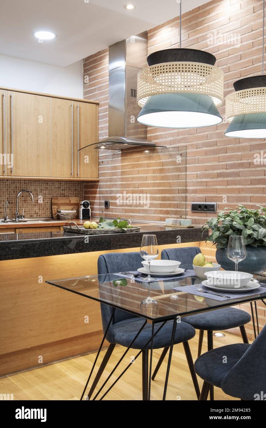 Studio apartment with open plan kitchen with glass dining table and