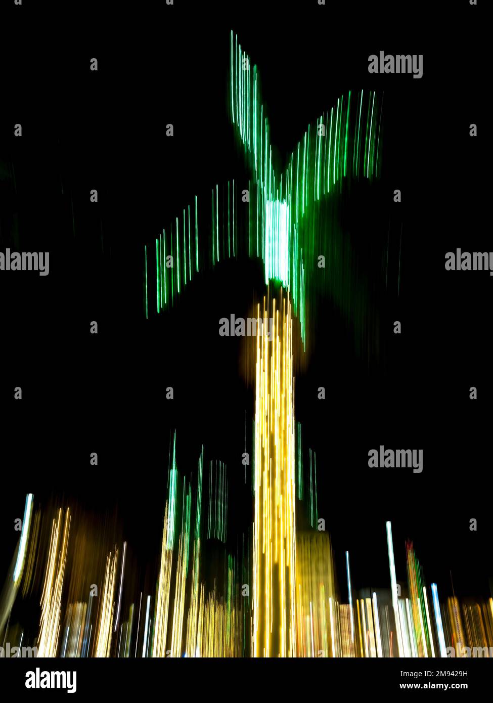 Abstract burred version of gold and green Christmas lights in palm