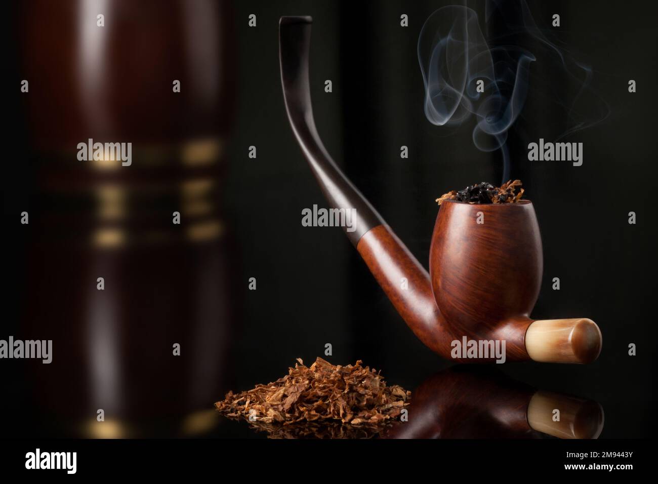 LIt wooden elegant brown tobacco pipe with tobacco and tobacco wooden