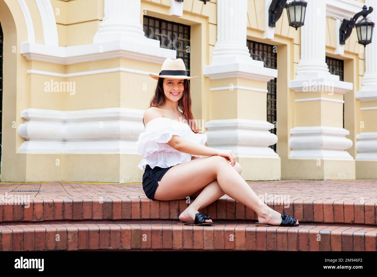 Beautiful young woman at the historical Municipal Theater built in 1918 located in the downtown of the city of Cali in Colombia Stock Photo