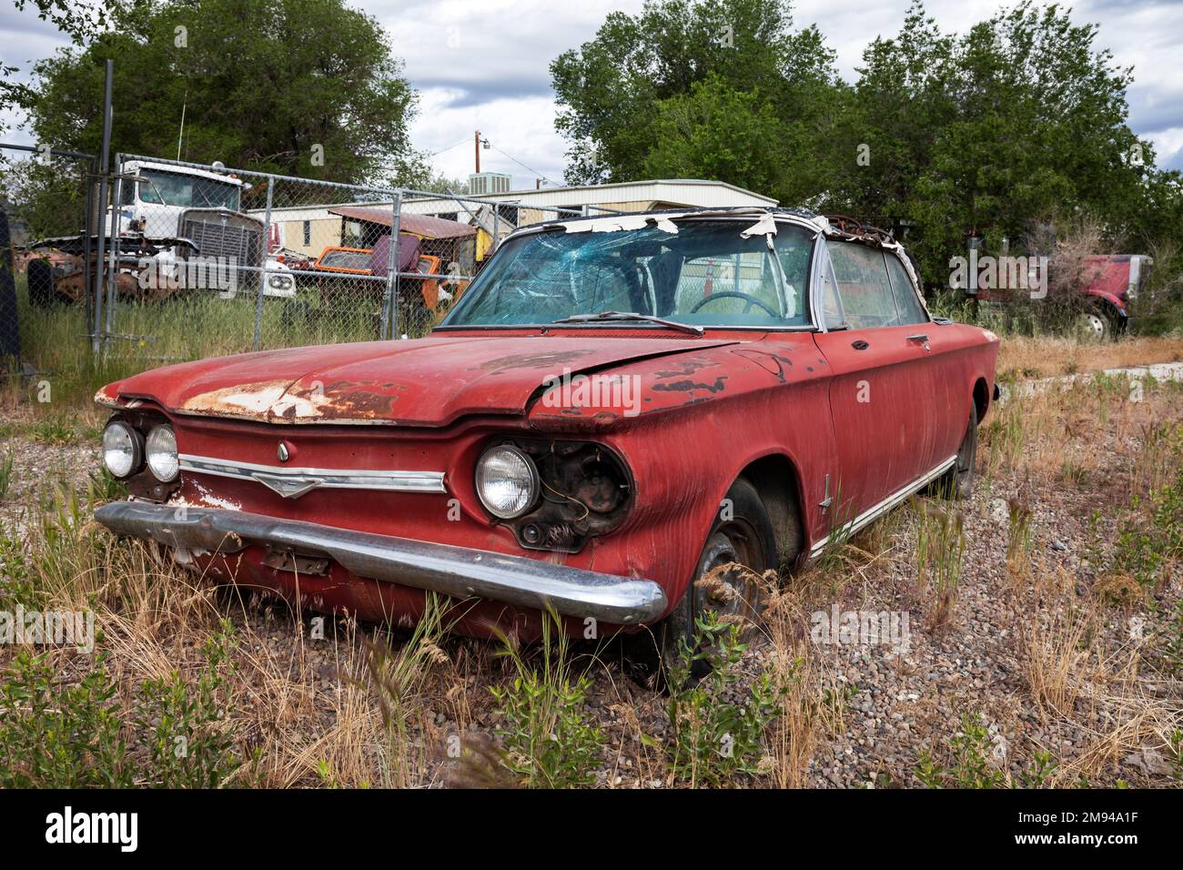 An early 1960's era Chevrolet Corvair convertible sits neglected in Wells, Nevada. Stock Photo