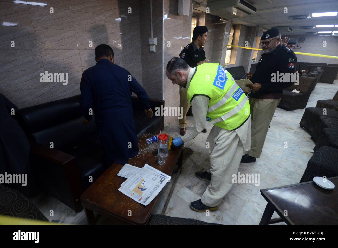 Pakistan. 16th Jan, 2023. Police officers examine the crime scene