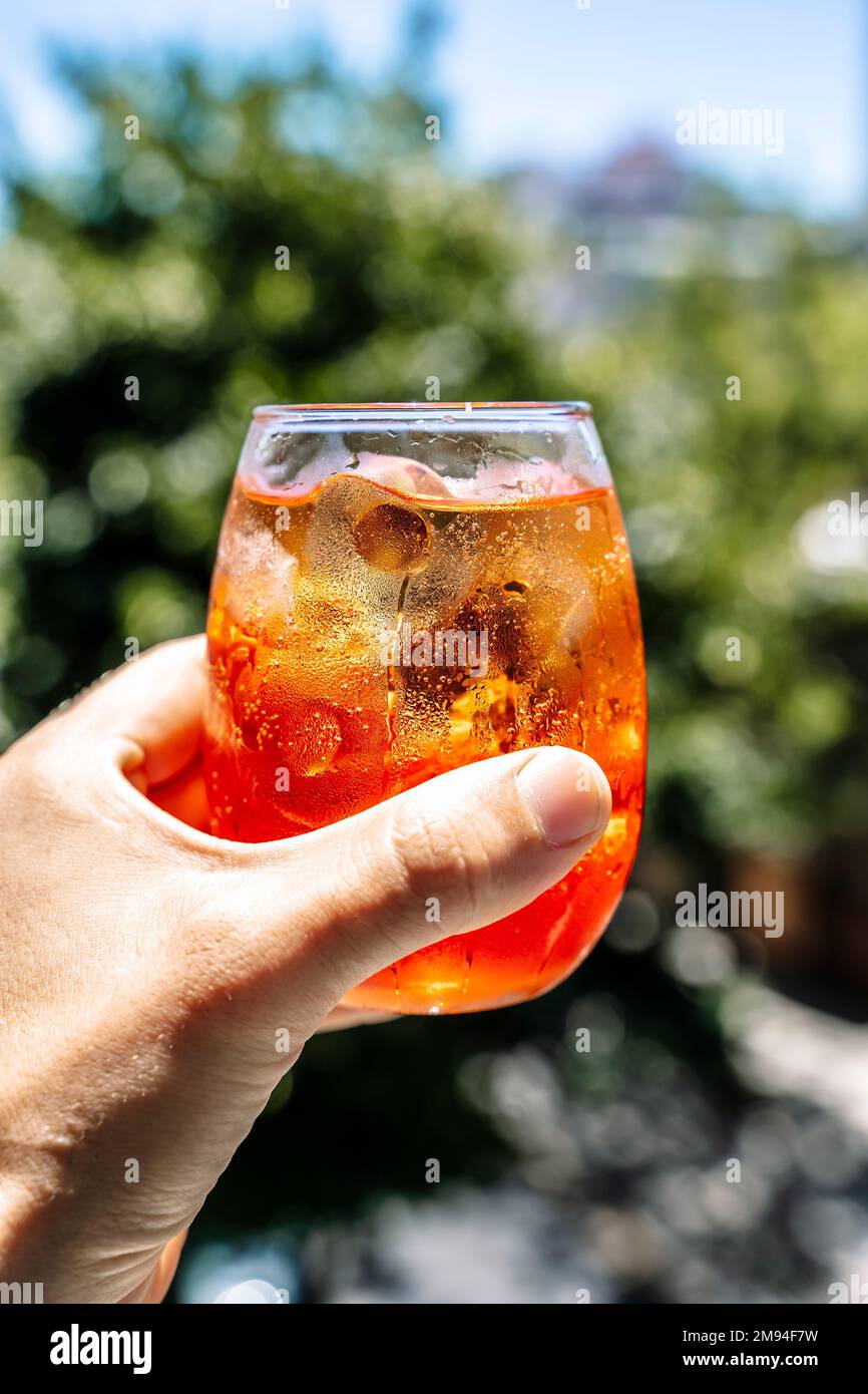 Cold cocktail. Summer soft drink with ice based on orange juice and syrup in a glass. High quality photo Stock Photo