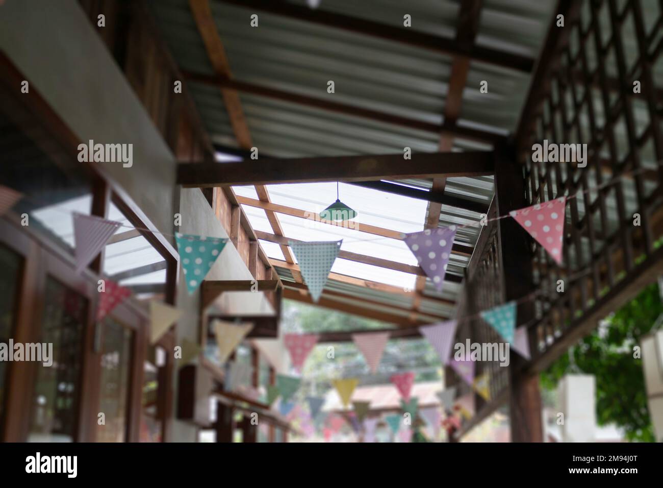 Festive colorful flags decorated on wooden architecture, stock photo ...