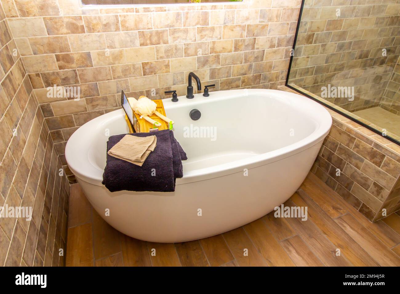 Modern Oval Bathtub With Bath Tray Stock Photo