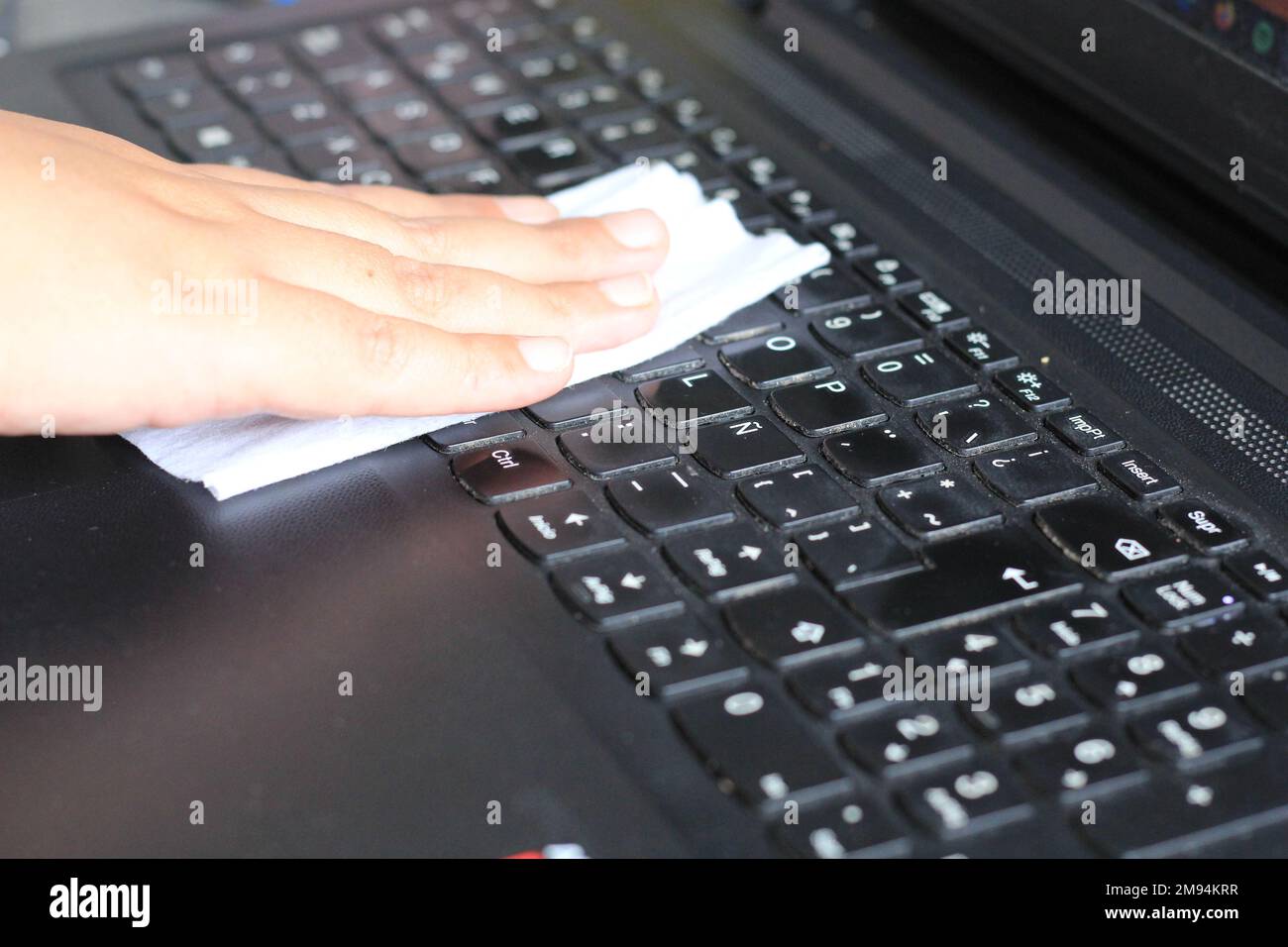 Clean computer keyboard with antibacterial wet towel, virus prevention