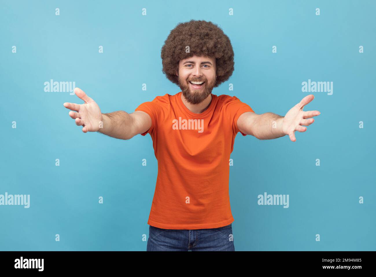Come into my arms. Portrait of satisfied man with Afro hairstyle