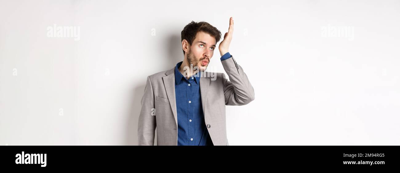 Someone Bothered Man shocked with someone very stupid. Annoyed businessman roll eyes and ...