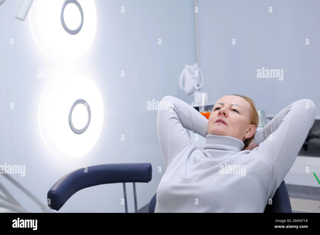 woman adult in dental clinic waiting for the doctor she put her hands
