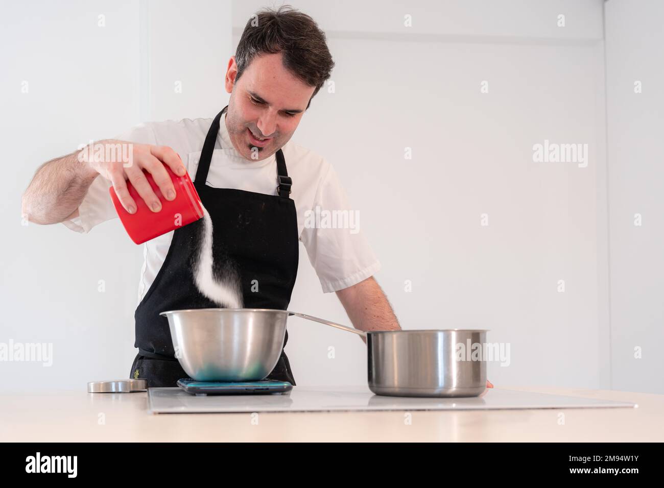 Challenger man cooking a red velvet cake at home, preparing Swiss