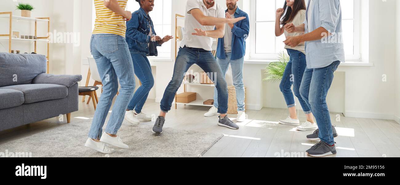 Group of people having a party at home, dancing, enjoying music and having fun together Stock Photo