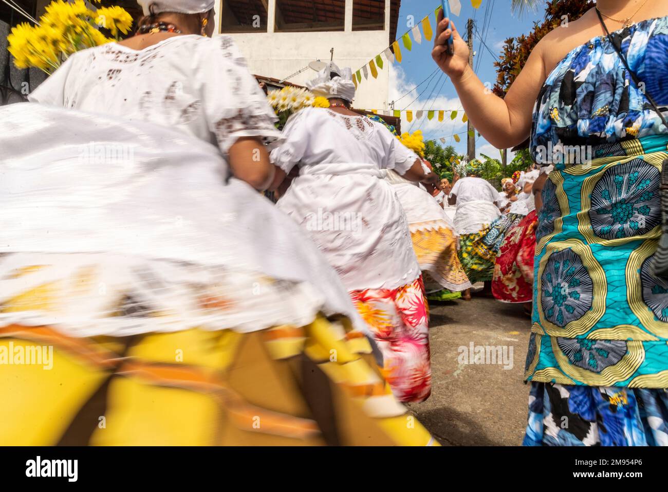 A view of Candomble members in traditional clothes during religious ...