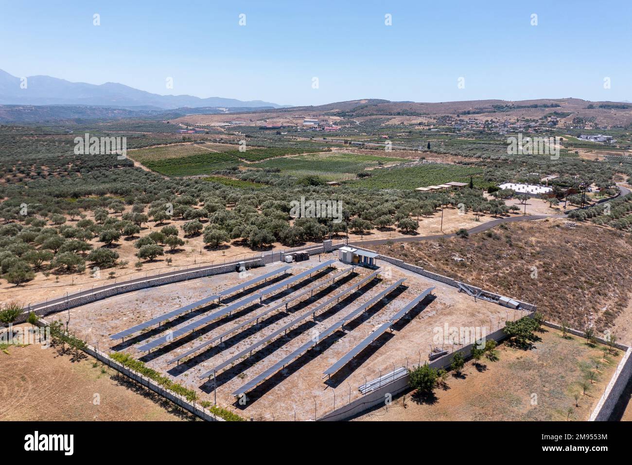 An aerial view of an open field filled with solar panels to generate ...
