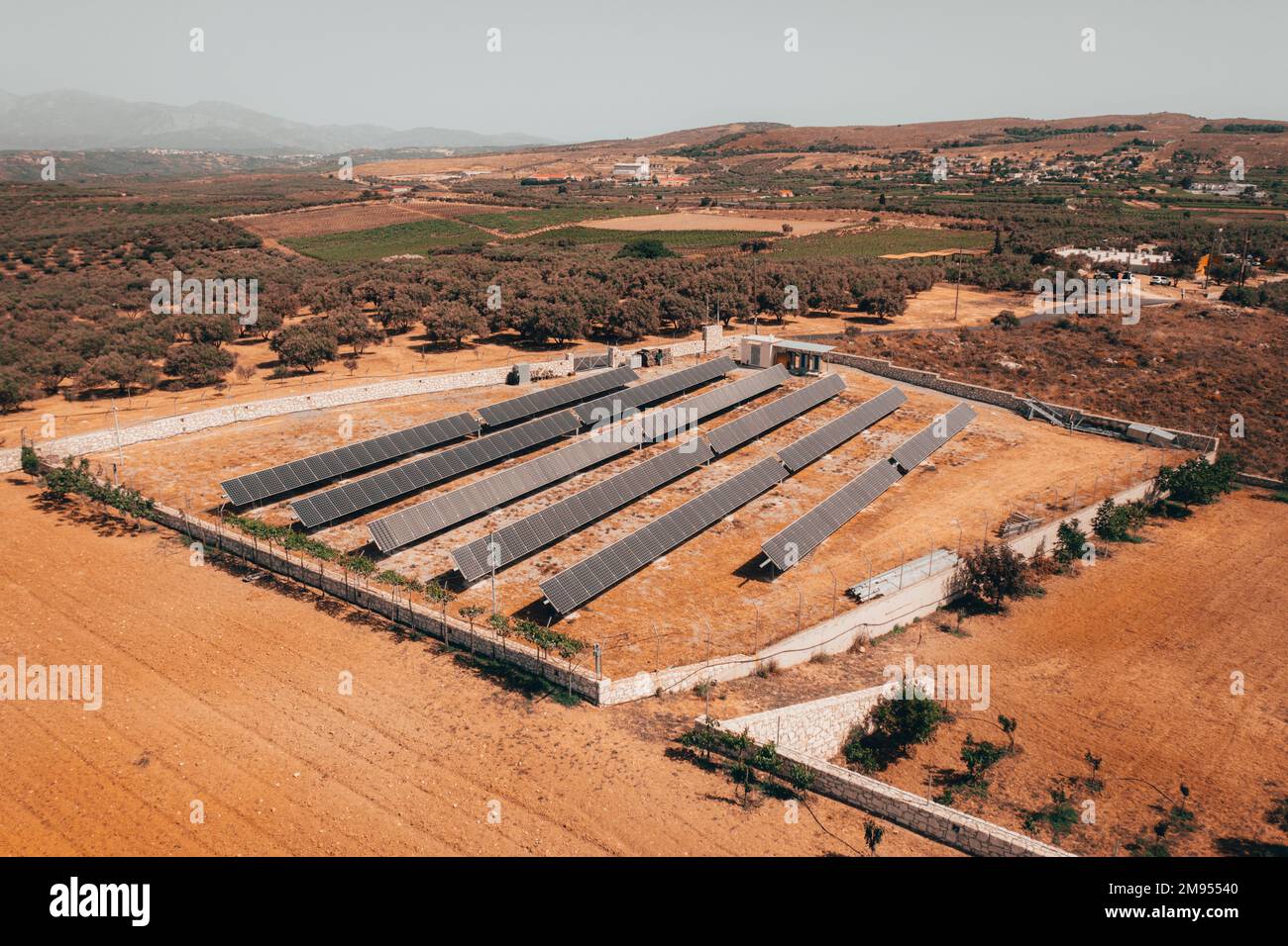 An aerial view of an open field filled with solar panels to generate ...