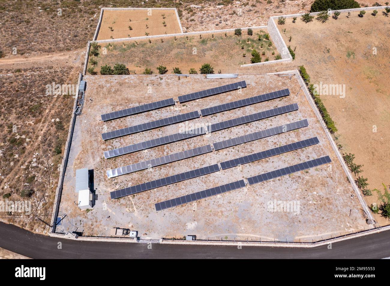 An aerial view of an open field filled with solar panels to generate ...