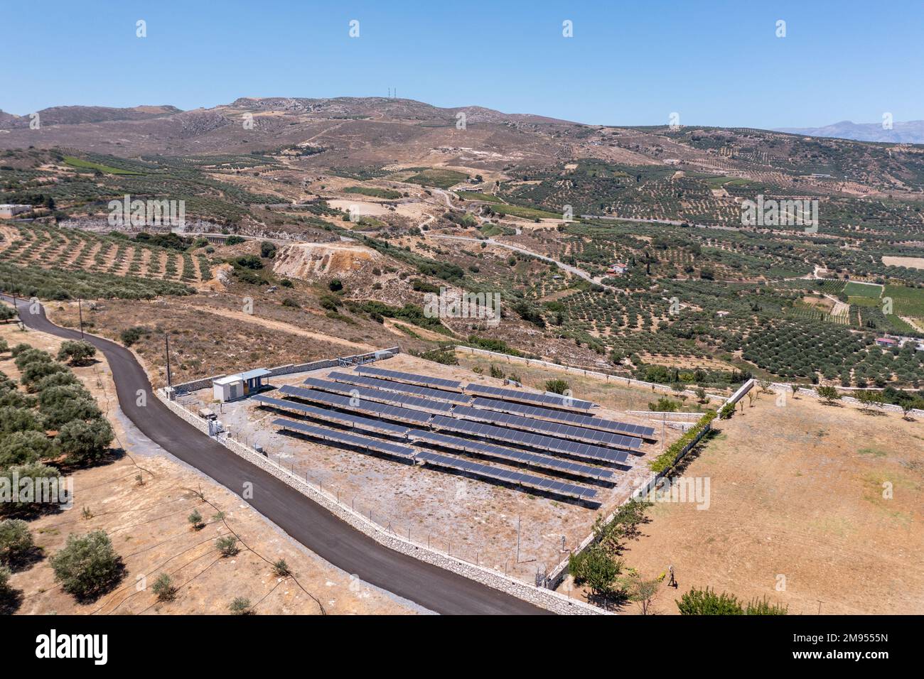 An aerial view of an open field filled with solar panels to generate ...