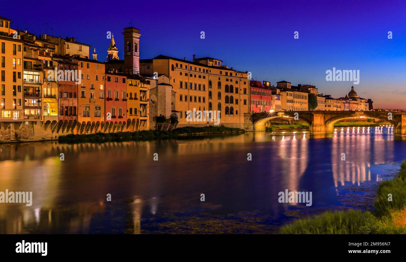 Sunset cityscape with the St Trinity Bridge or Ponte Santa Trinita on the river Arno River in Centro Storico, Florence, Italy at sunset blue hour Stock Photo