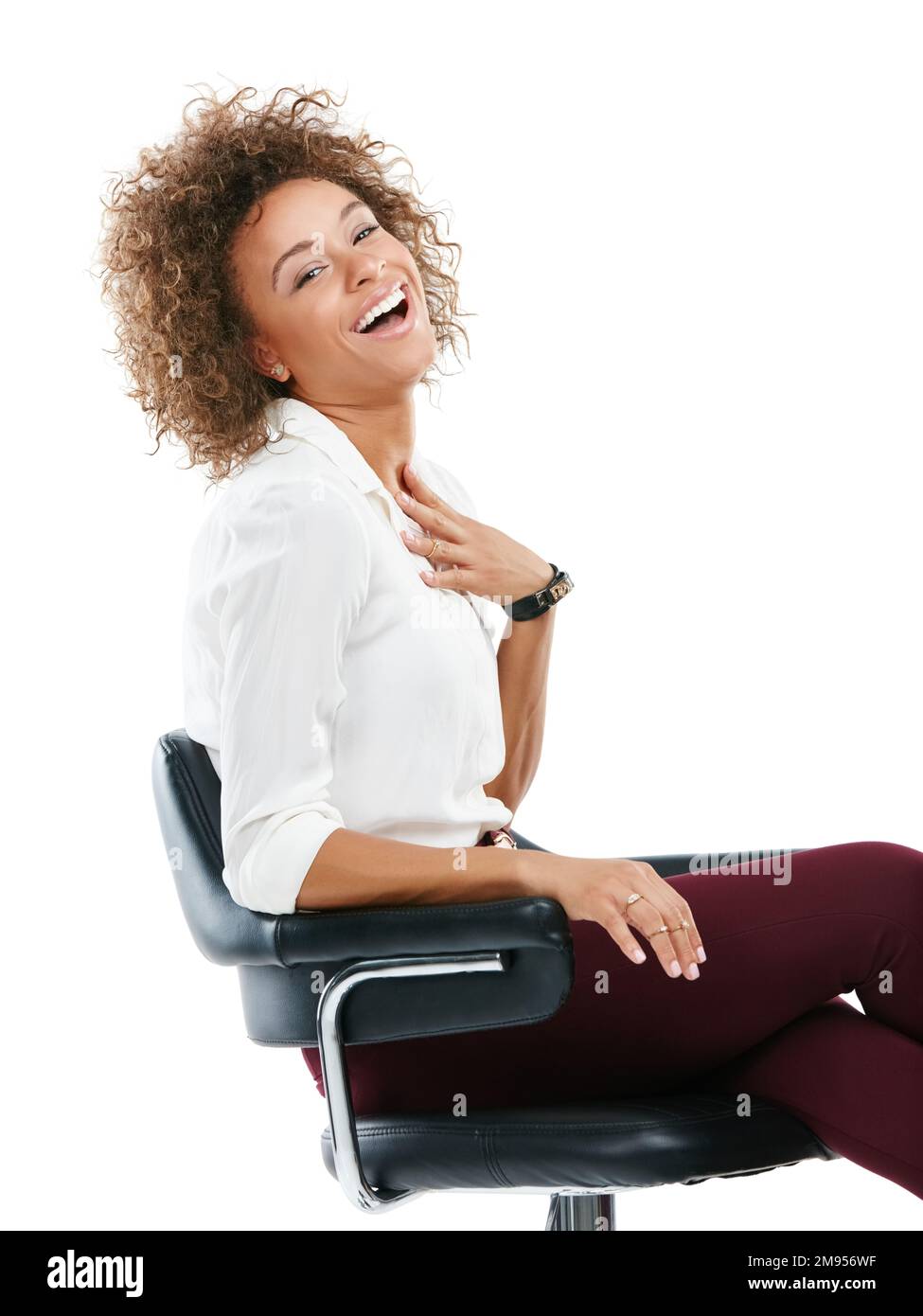 Business woman, smile and laughing in chair while sitting against white studio background. Portrait of isolated happy female worker smiling in Stock Photo