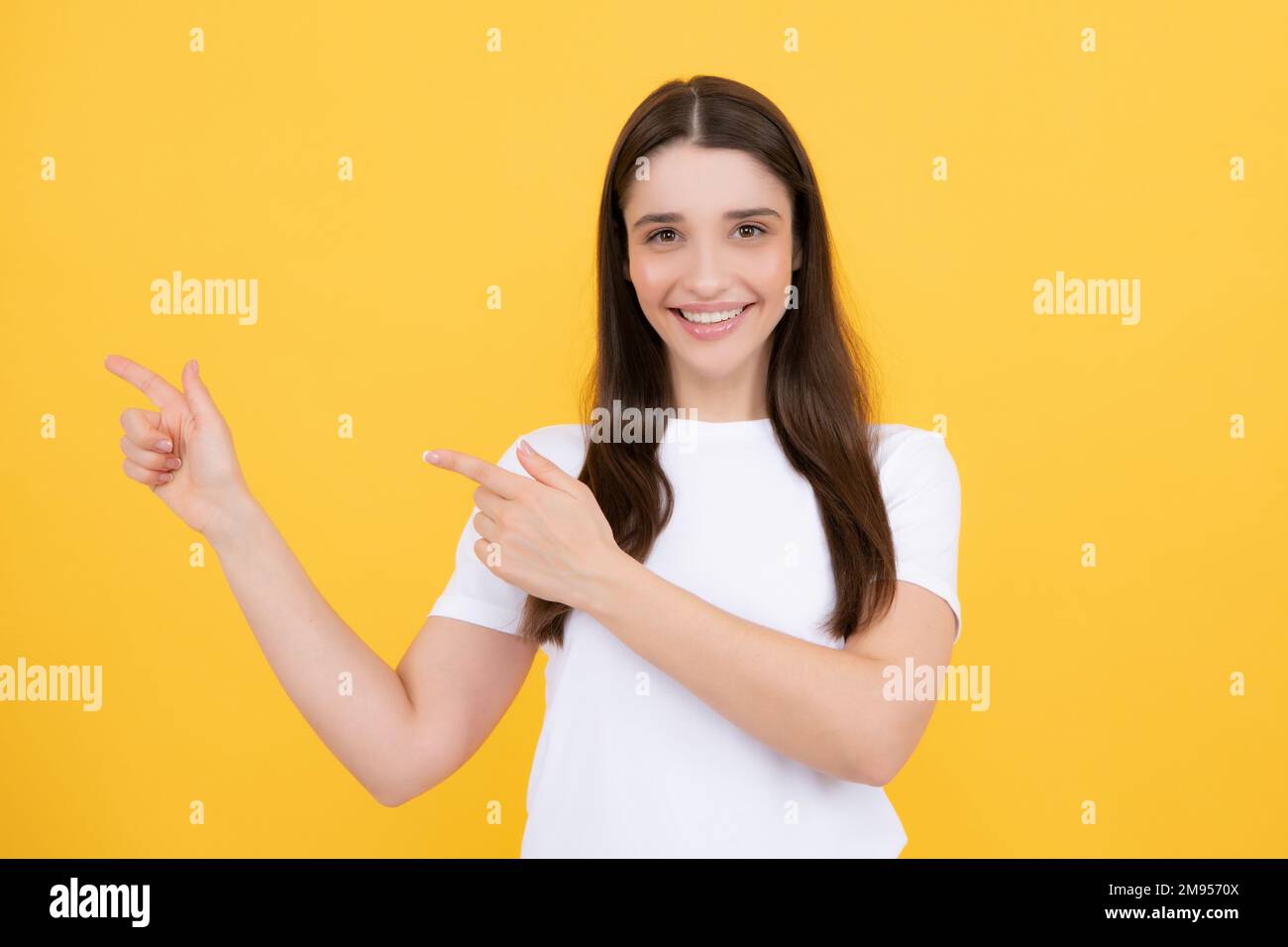 Woman point at copy space, showing copyspace pointing. Promo, girl ...