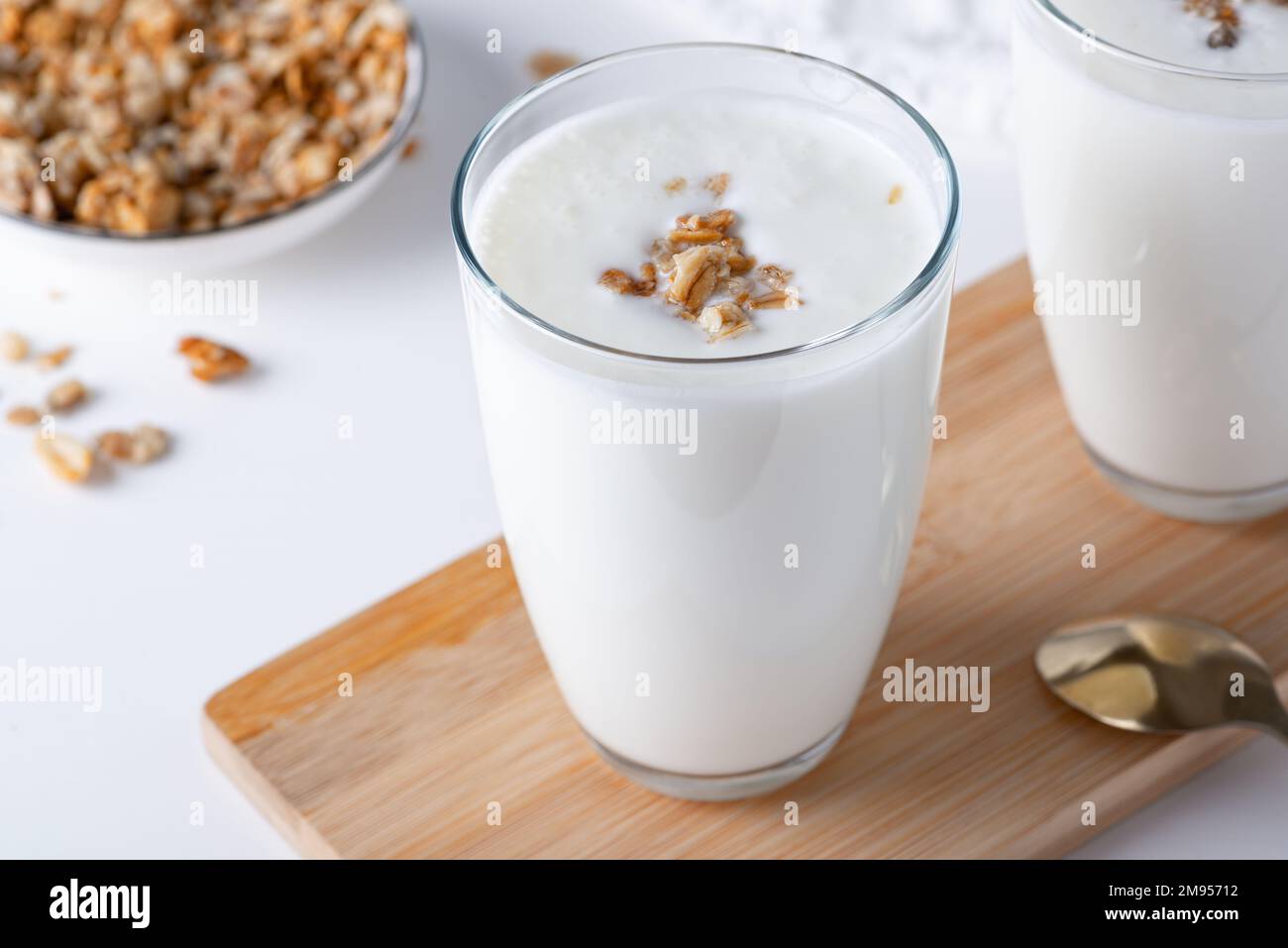 Kefir, buttermilk or yogurt with granola. Yogurt in glass Stock Photo