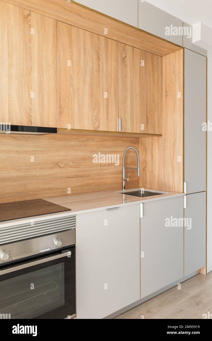 Closeup of piece of modular kitchen furniture made of light wood