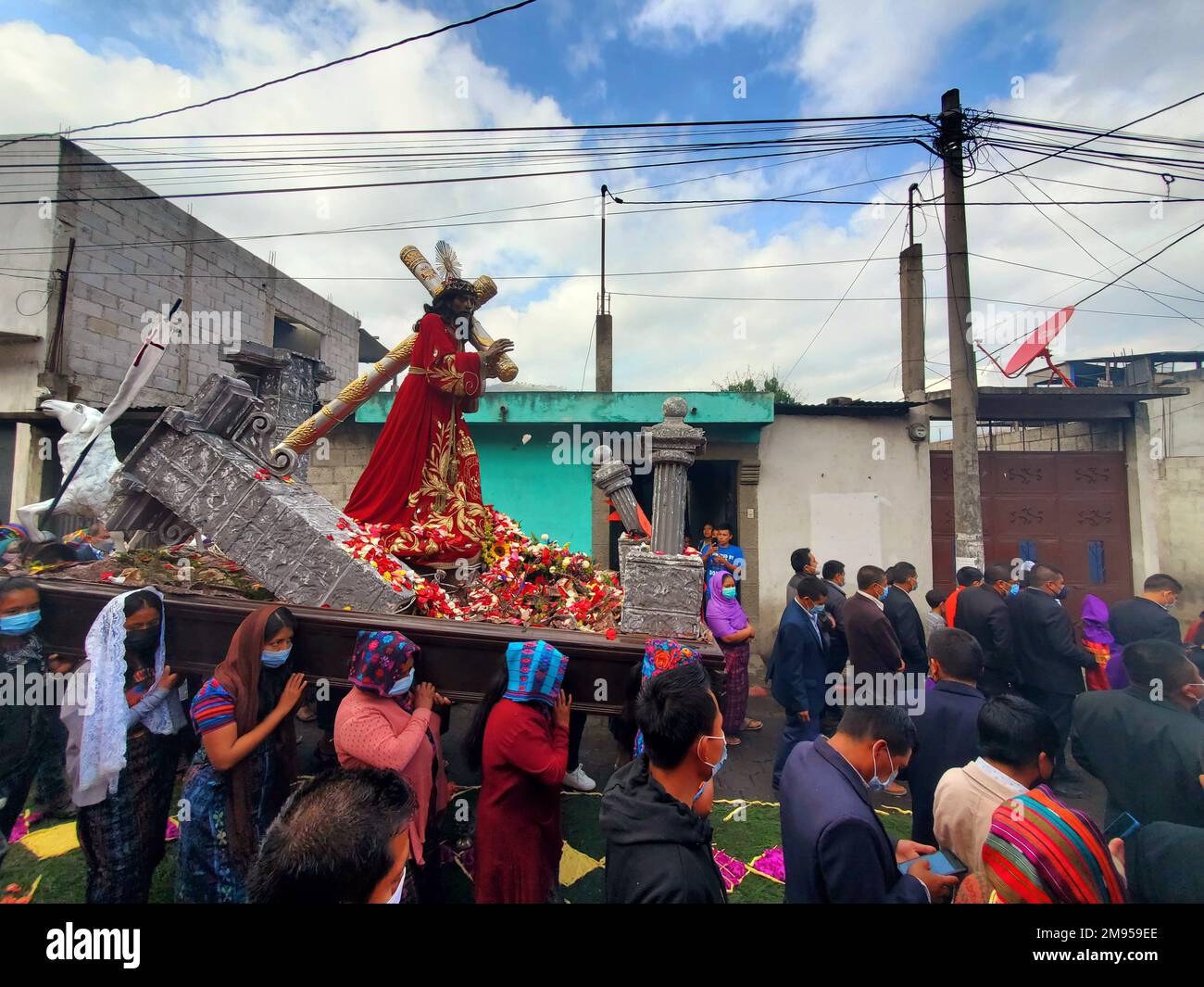 Holy Week Procession in Rural Mayan Kaqchikel village, San Antonio Aguas Calientes, near Antigua Guatemala with people wearing masks Stock Photo