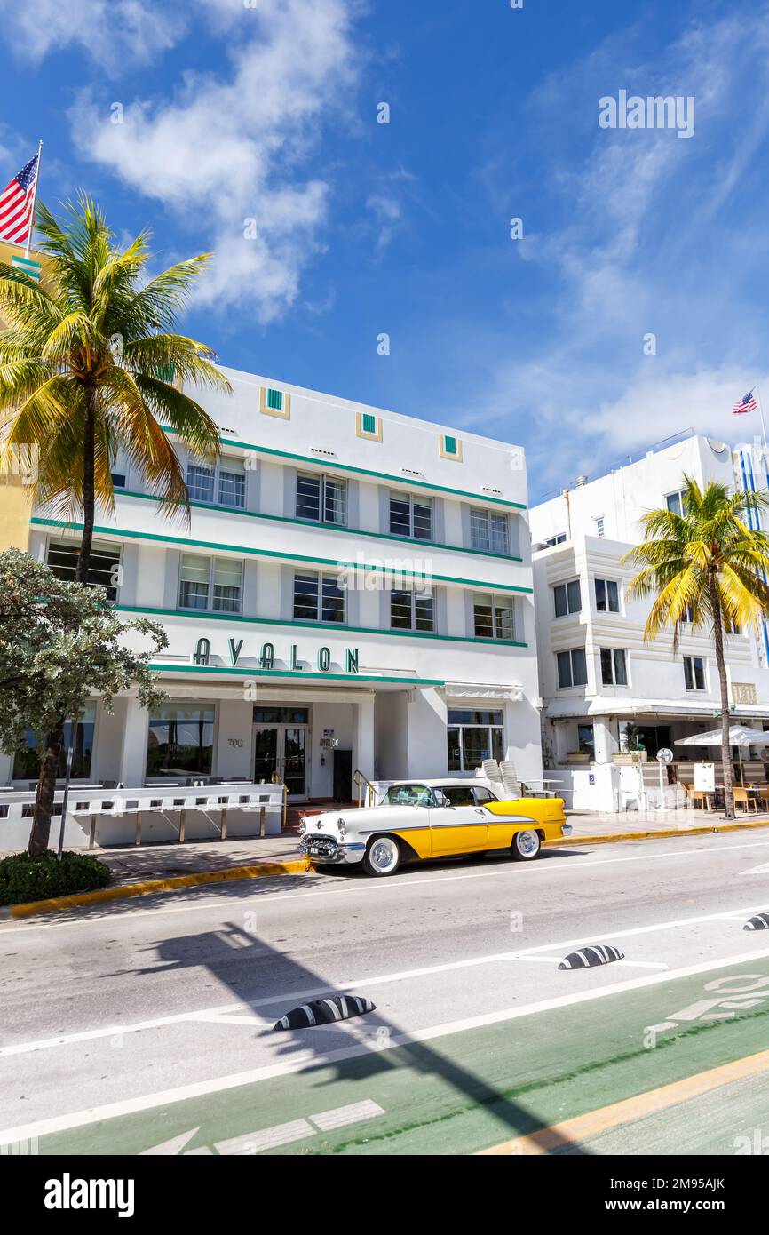 Miami Beach, United States - November 15, 2022: Avalon Hotel in Art Deco architecture style and classic car portrait format on Ocean Drive in Miami Be Stock Photo