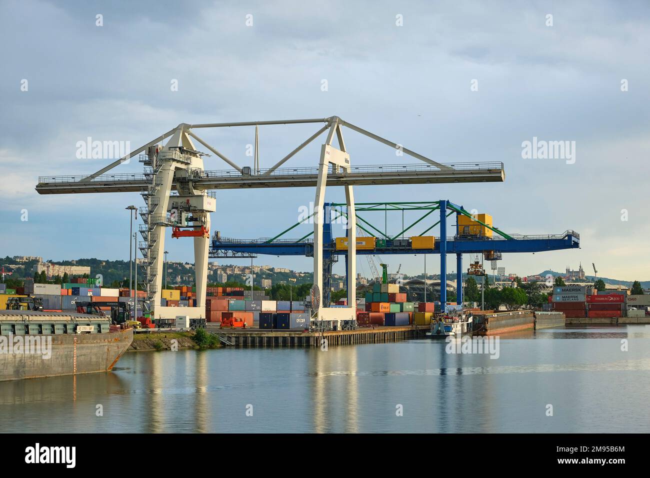 Lyon Edouard Herriot Port, multimodal hub on the River Rhone, partly owned by the Compagnie Nationale du Rhone (CNR). Port crane and container ship Stock Photo