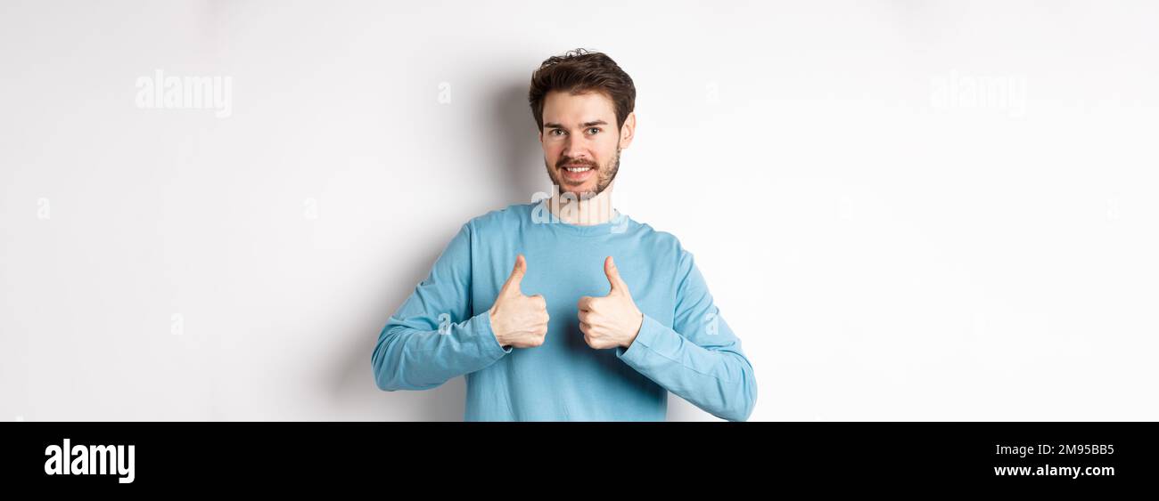 Good choice. Attractive caucasian man with beard showing thumbs up and ...
