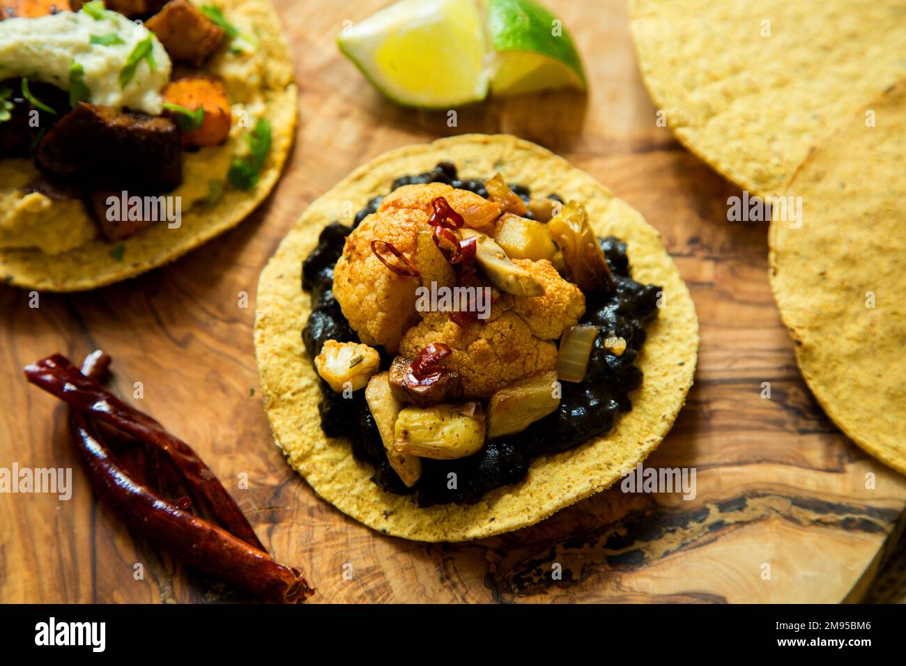 Vegetarian tostadas with hummus. Tostada, name given to various dishes in Mexico that include a