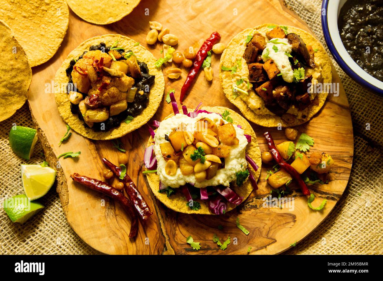 Vegetarian tostadas with hummus. Tostada, name given to various dishes in Mexico that include a toasted tortilla as the main base of its preparat Stock Photo