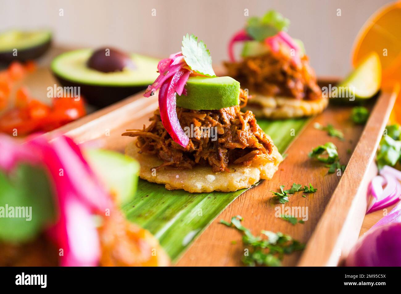 Tostada with pulled pork and avocado. Tostada, name given to various
