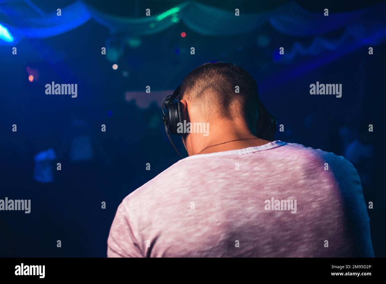 head of a DJ with headphones playing at the event in a Stock
