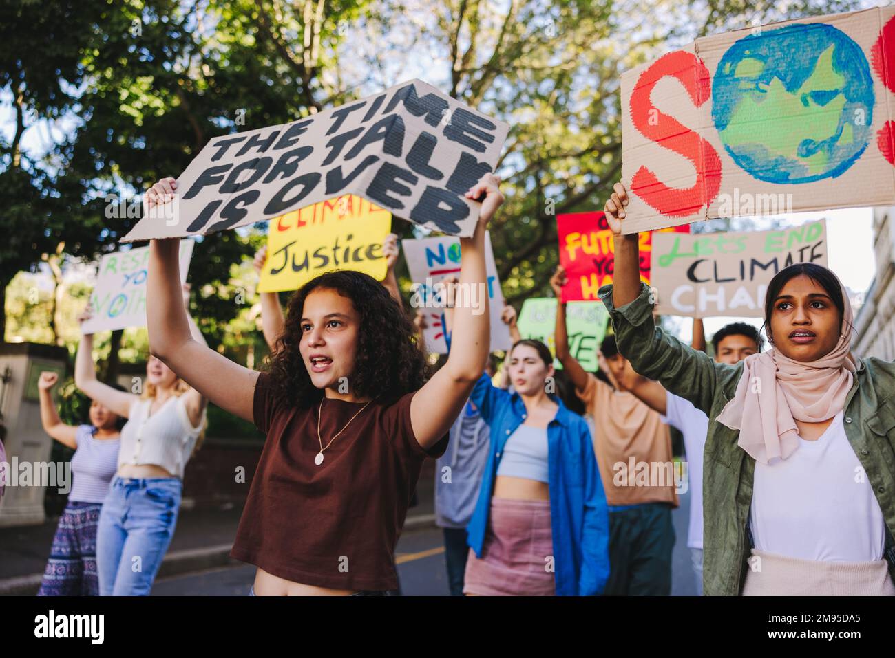 Group of teenagers standing up against climate change and global ...