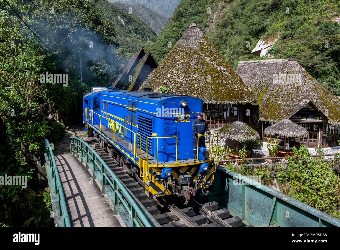 A Peru Rail train driven by a diesel engine moves towards Machu Picchu
