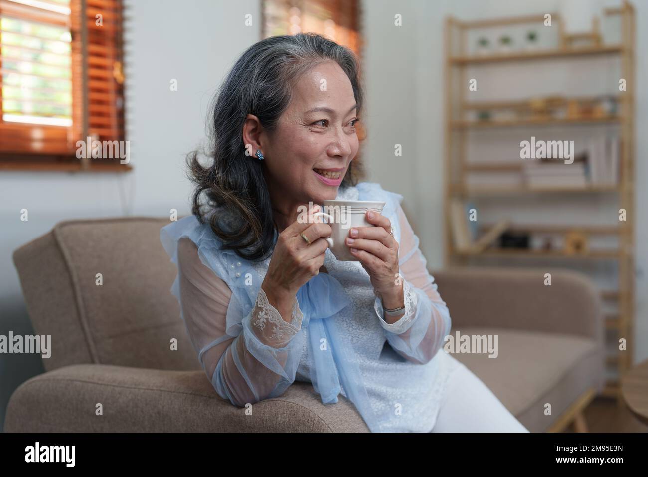 Senior woman good healthy drinking tea or coffee at home. Exercise and healthy diet concept Stock Photo