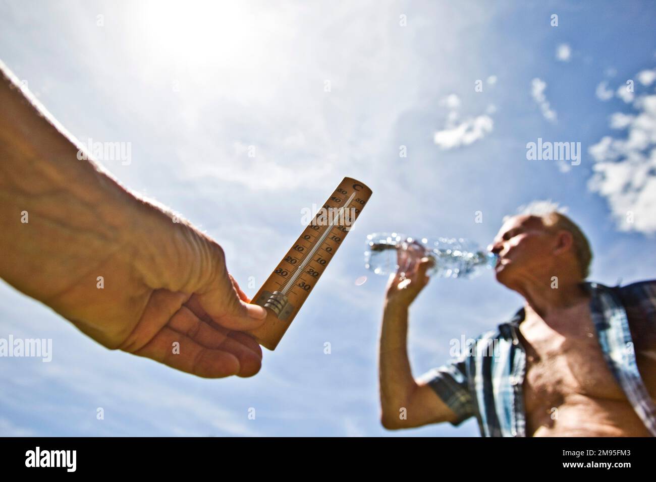 Senior citizens and heat wave: staying hydrated. Intense heat: thermometer and old man under the sun drinking water. Illustration, elderly people and Stock Photo