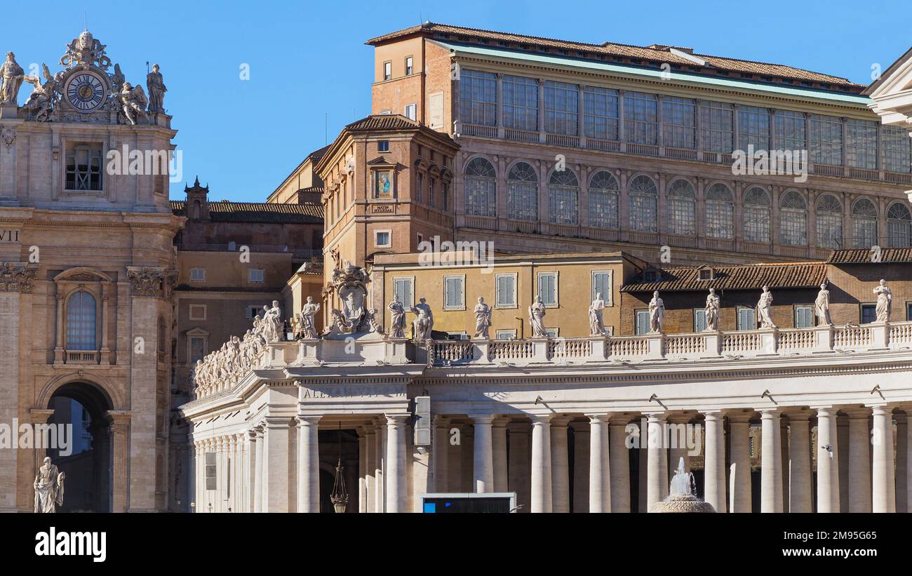 Upper part of Doric Colonnades with large statues next to famous St. Peter's Basilica, Sistine Chapel, Apostolic palace. Baroque architecture, Vatican Stock Photo