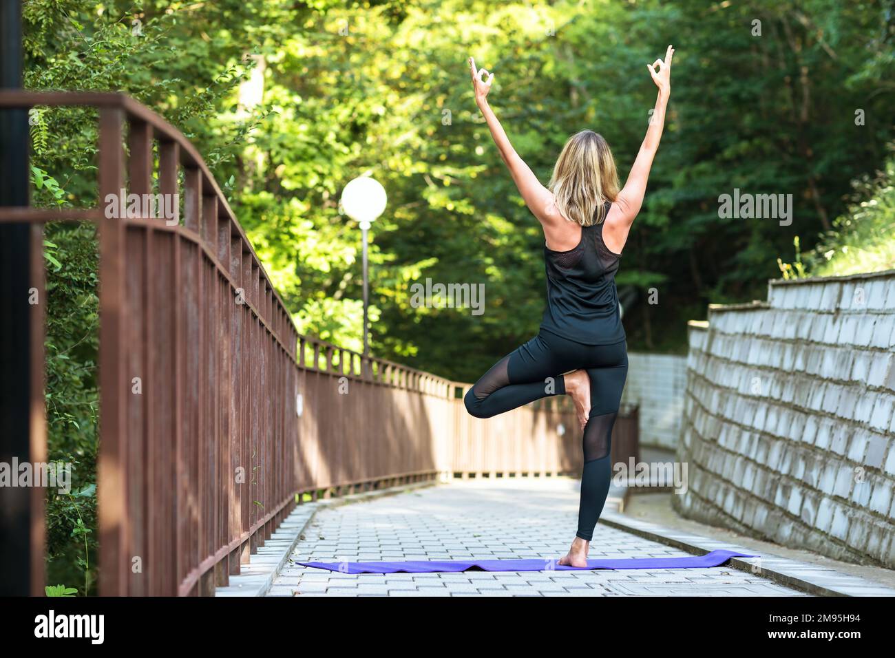Woman leading a healthy lifestyle and practicing yoga, doing ...