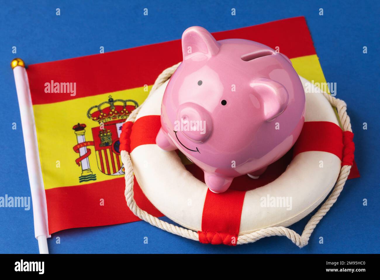 Piggy bank, lifebuoy and flag on a blue background, concept on the