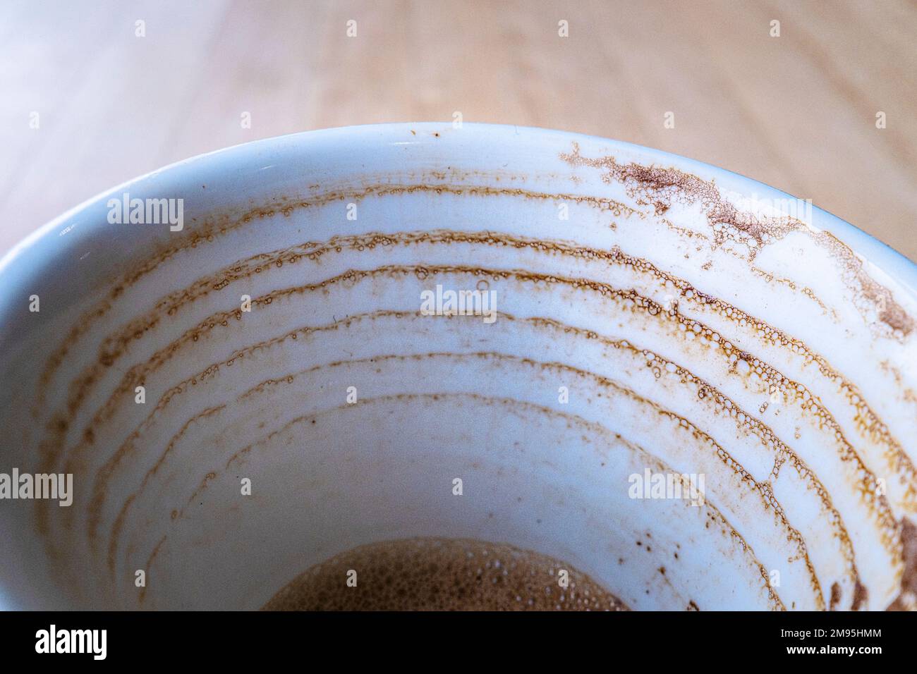 A close uo view of dried coffee rings on the inside of a cup. Stock Photo