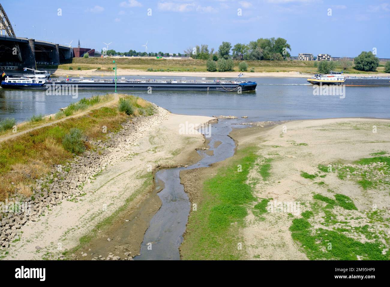 Netherlands, Ooyse Schependom, August 23, 2022: river transport on the River Waal, Rhine delta, during the drought of summer 2022. Chemical tanker. Th Stock Photo