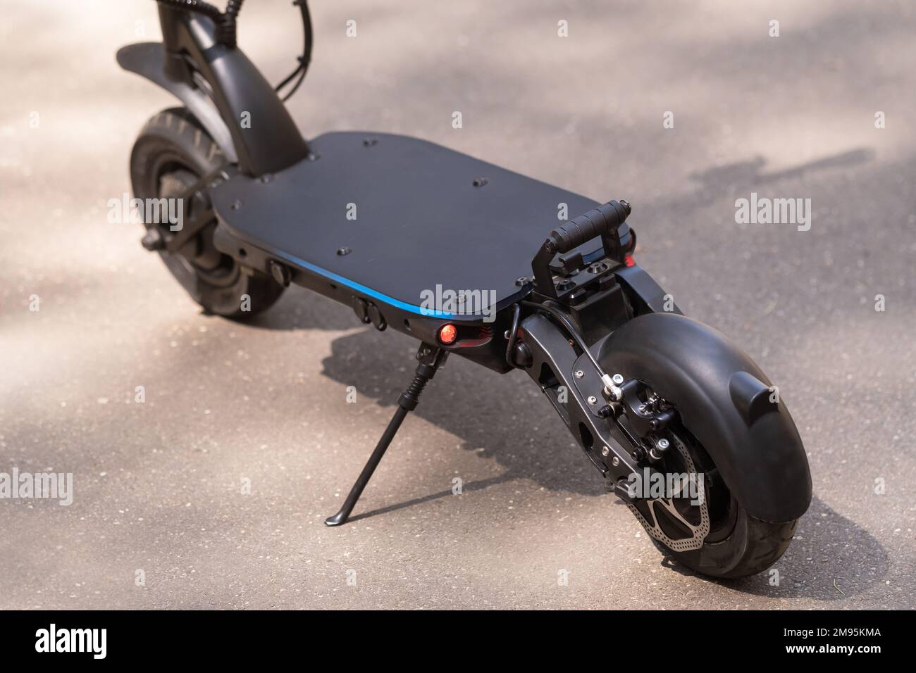 Black Electric scooter standing on the running board on the street