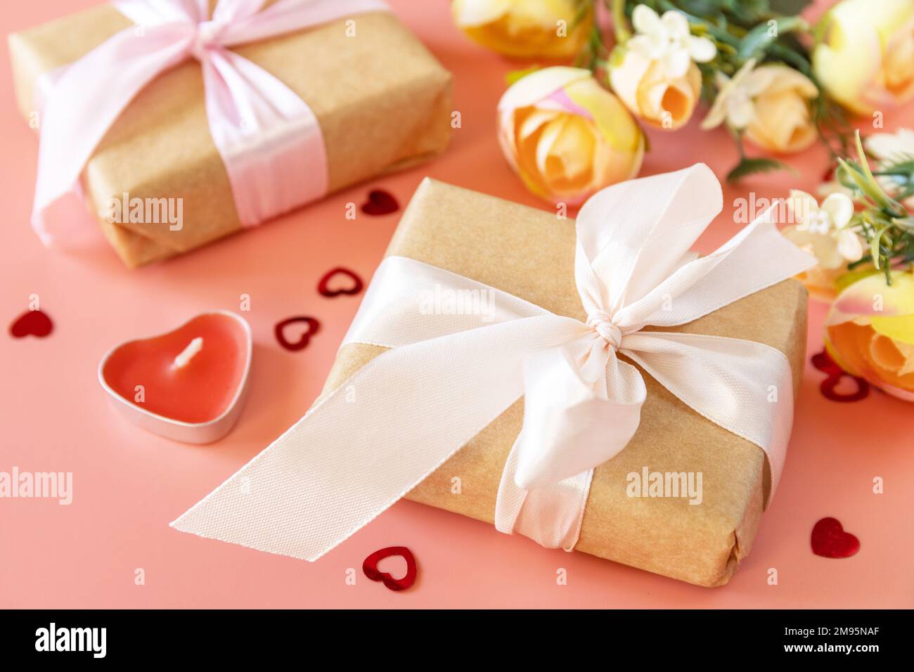 Valentine's Day, Women's Day, birthday, mothers day greeting card background with handmade present box and spring flower on pink background. Stock Photo