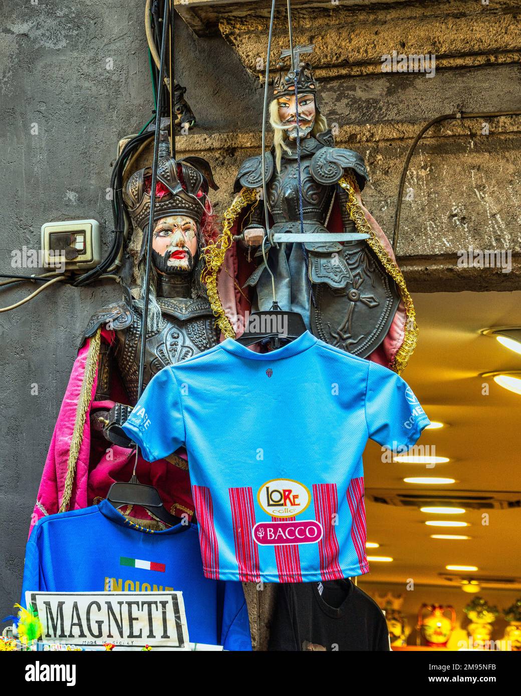 The Sicilian puppets, the traditional Sicilian puppets on display for sale, and the shirts of famous players offered as souvenirs. Catania, Sicily Stock Photo