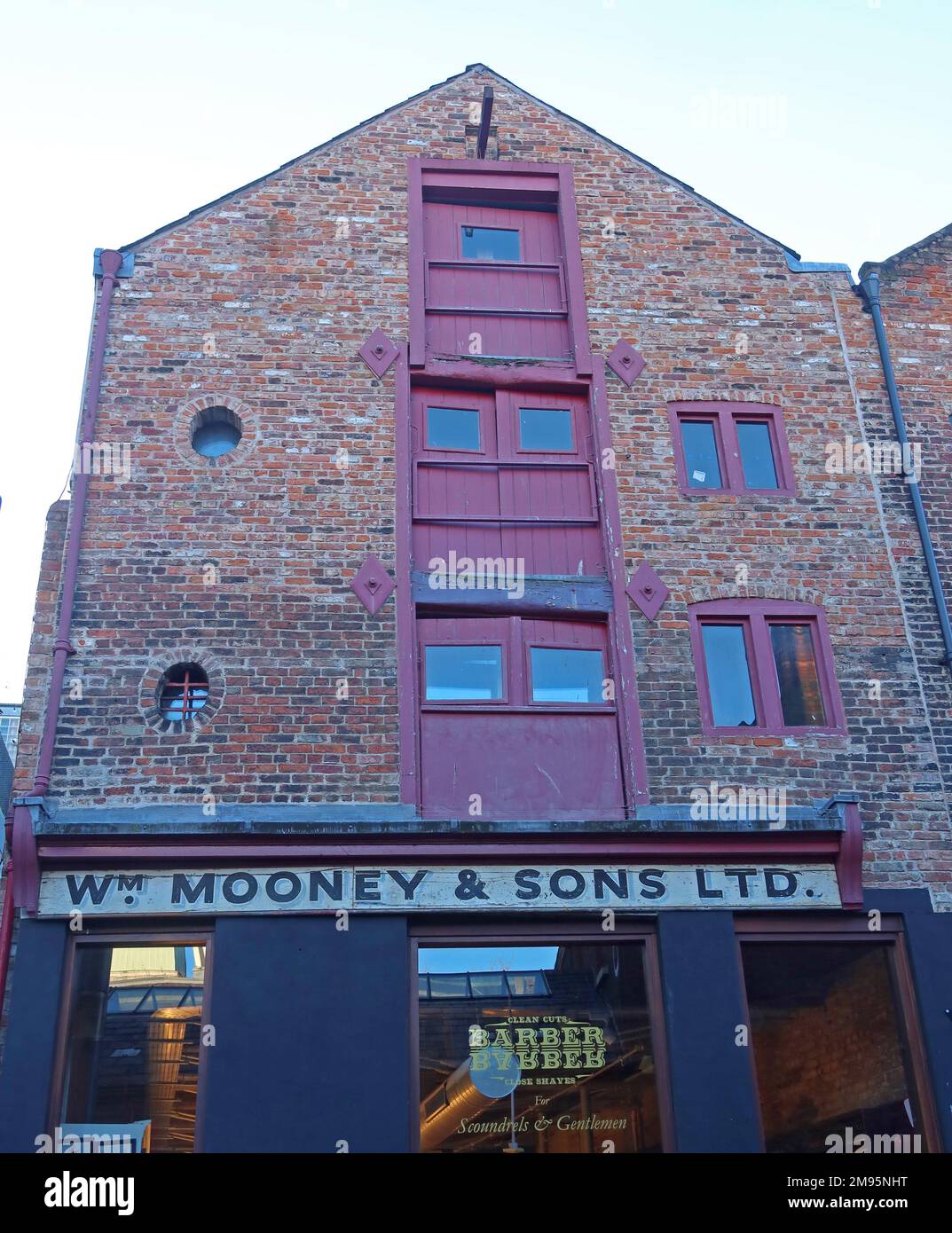 BarberBarber, in  Wm Mooney & Sons Ltd, old warehouse building, in College Lane, Liverpool, Merseyside, England, UK, L1 3BN Stock Photo