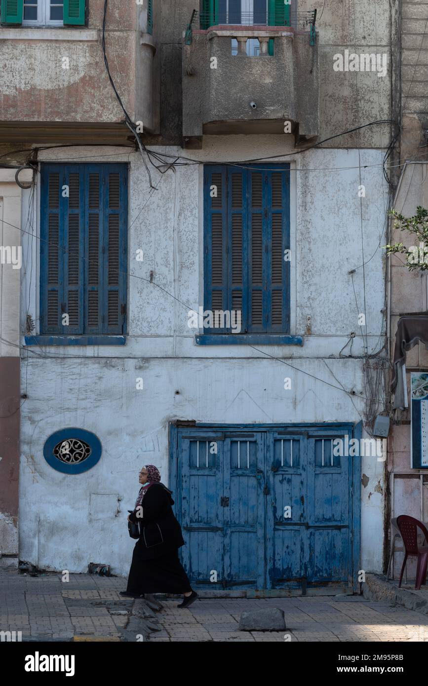 Alexandria, Egypt. December 3rd 2022.  Blue painted doors and windows of faded traditional architecture along the Corniche of the north Egyptian Delta Stock Photo