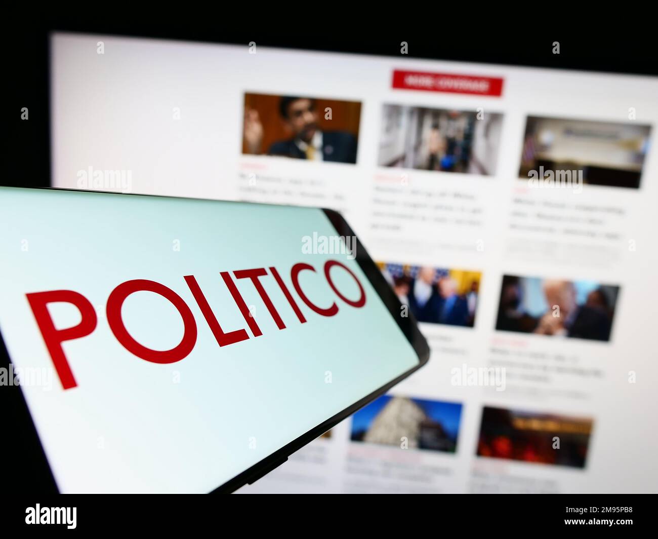 Cellphone with logo of American political newspaper company Politico LLC on screen in front of website. Focus on center-left of phone display. Stock Photo