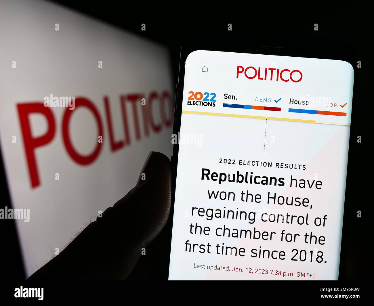 Person holding smartphone with webpage of US political newspaper company Politico LLC on screen with logo. Focus on center of phone display. Stock Photo