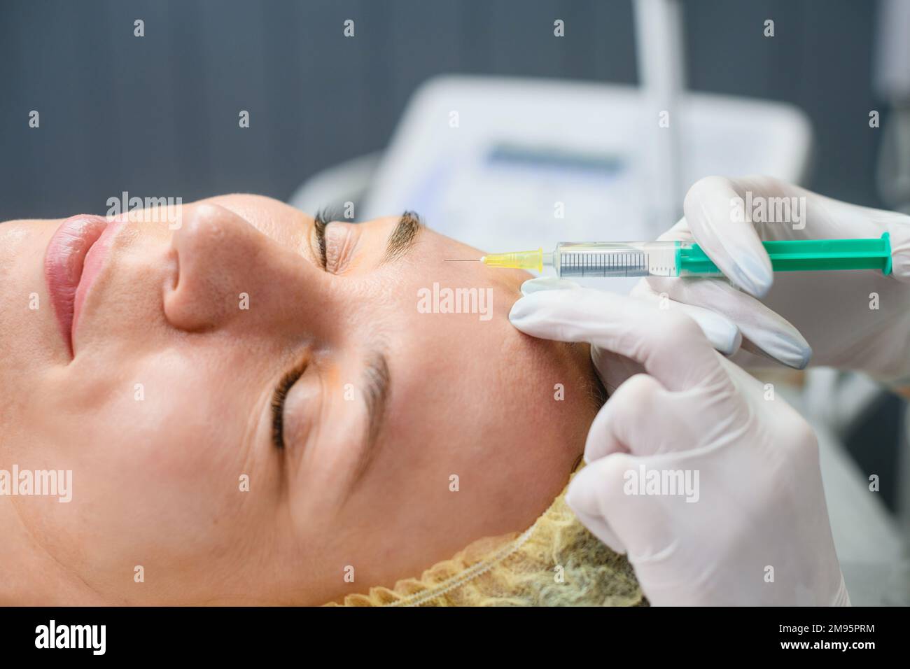 Close up female face with syringe needle, beauty botox injections in